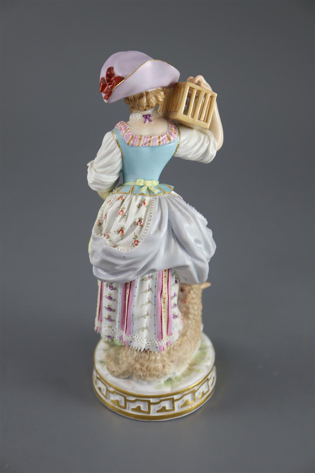 A Meissen figure of a shepherdess releasing a bird from a cage, 19th century, 17.5cm high